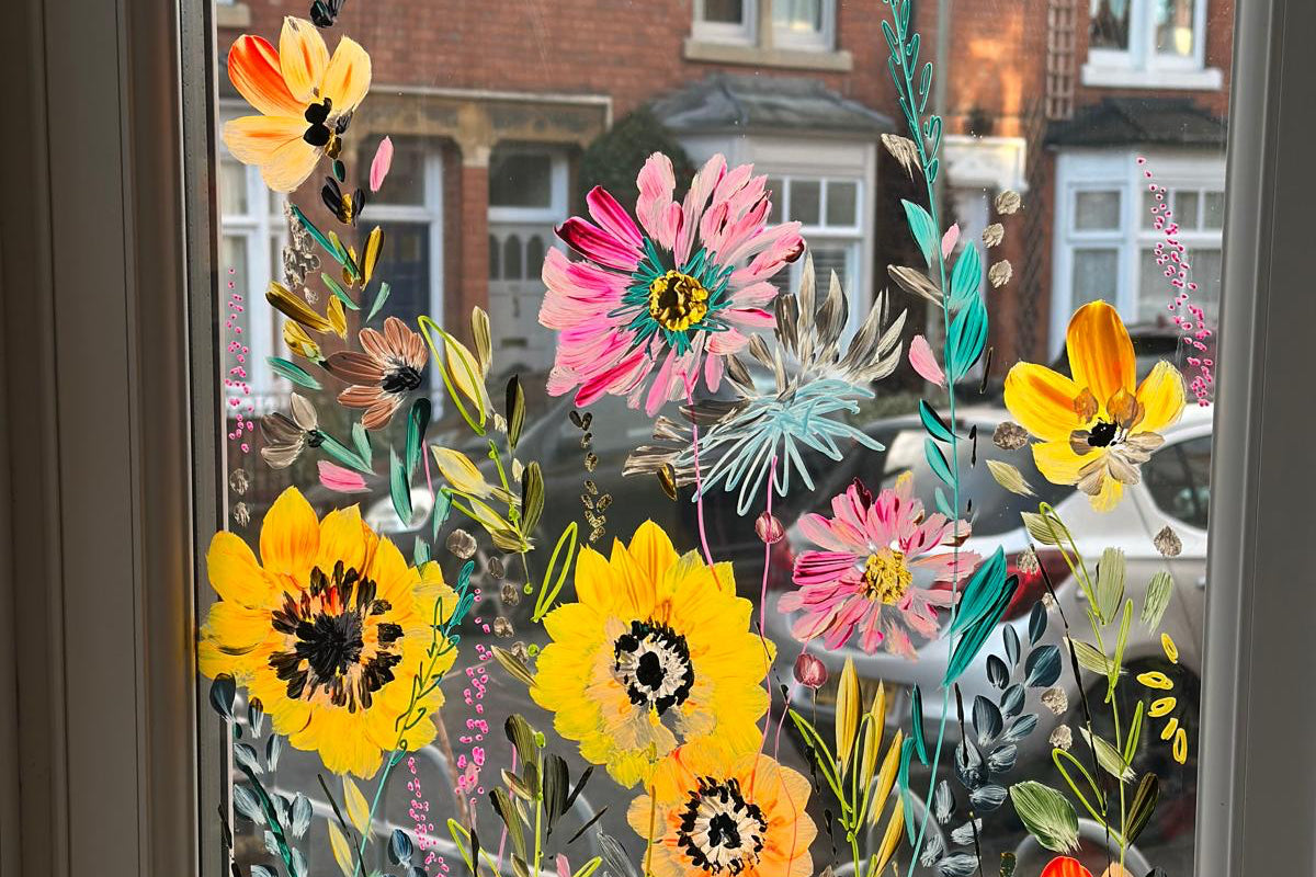 Decorative floral window film with colorful flowers on a glass pane.